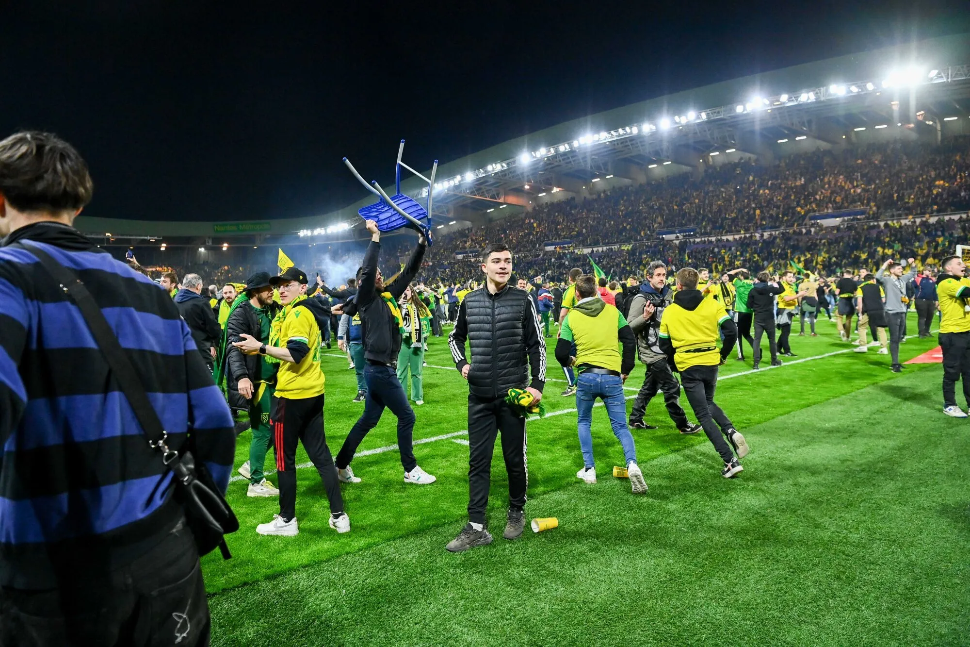 Fans of Nantes invade the pitch to celebrate the victory during the French Cup, semi final match between Nantes and Lyon at Stade de la Beaujoire on April 5, 2023 in Nantes, France. (Photo by Anthony Dibon/Icon Sport)