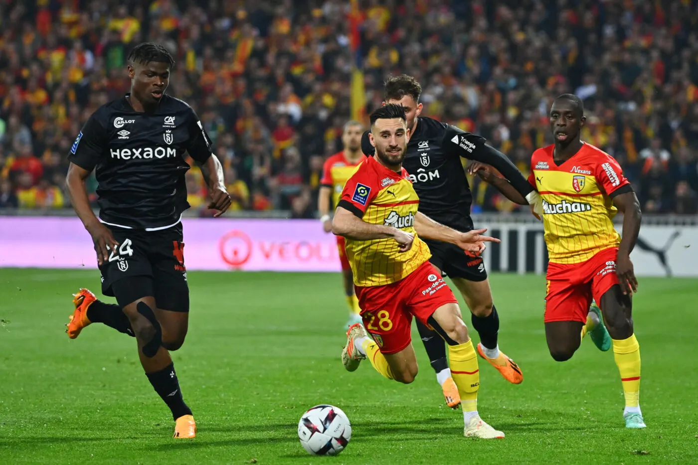 Emmanuel AGBADOU of Reims and Adrien THOMASSON of Rc Lens during the  Ligue 1 Uber Eats match between Lens and Reims on May 12, 2023 in Lens, France. (Photo by Anthony Dibon/Icon Sport)