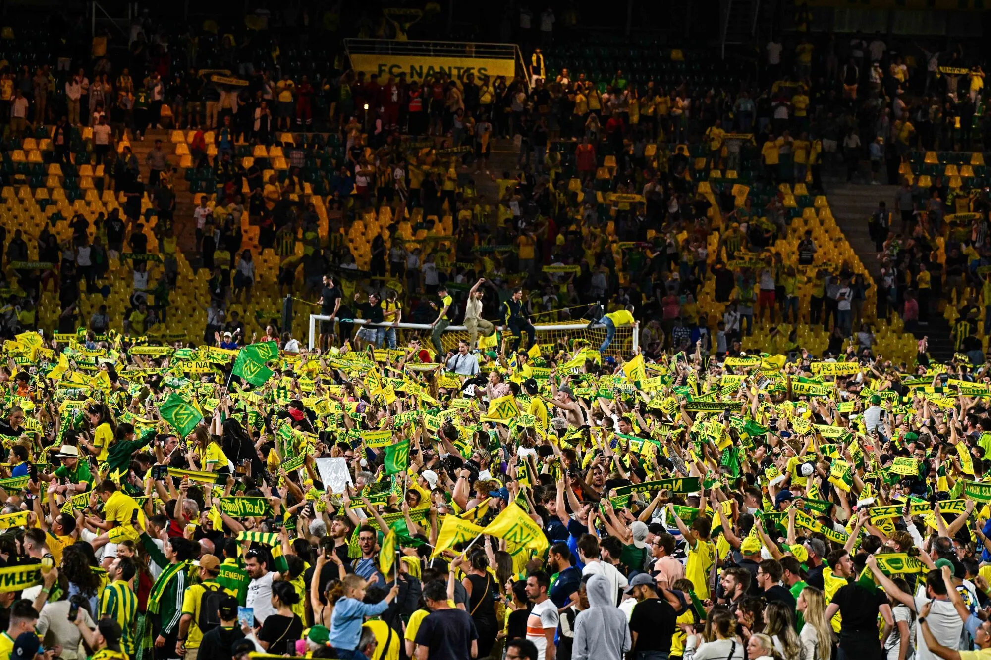 Fans of Nantes invades the pitch to celebrate during the French Ligue 1 Uber Eats soccer match between Nantes and Angers SCO at Beaujoire Stadium on June 3, 2023 in Nantes, France. (Photo by Baptiste Fernandez/Icon Sport)