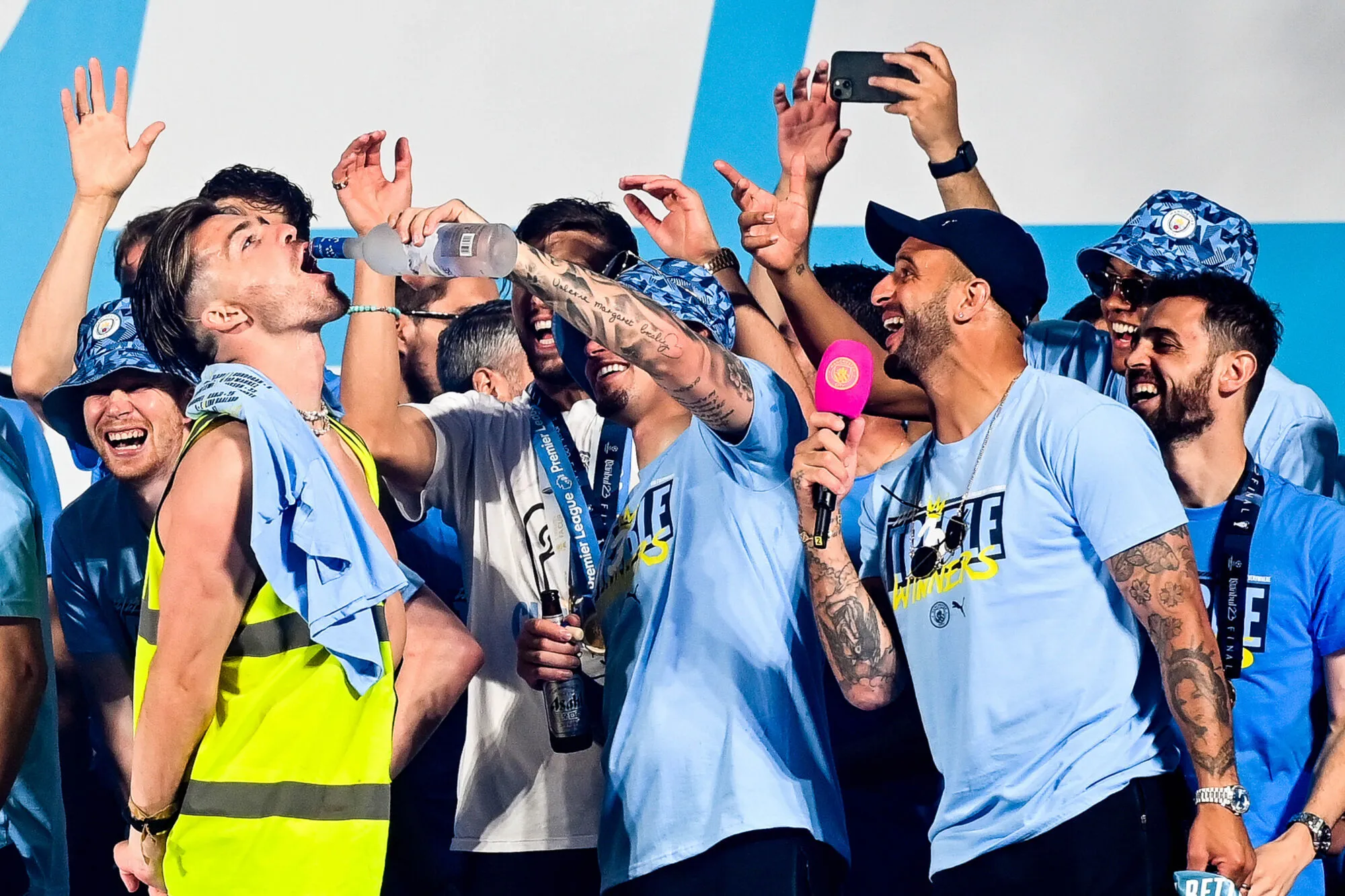 Kalvin Phillips pours a drink into Jack Grealish’s mouth as the players watch on during their Treble winning Victory Parade ending at the Town Hall, Manchester. Picture date: 12th June 2023. Picture credit should read: Gary Oakley/Sportimage - Photo by Icon sport