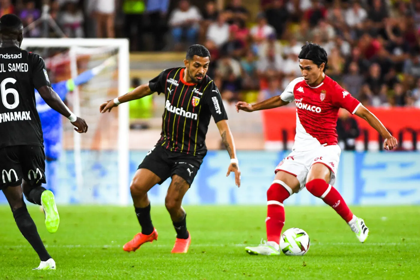Facundo MEDINA of Lens and Takumi MINAMINO of Monaco during the Ligue 1 Uber Eats match between Association Sportive de Monaco Football Club and Racing Club de Lens at Stade Louis II on September 2, 2023 in Monaco, Monaco. (Photo by Daniel Derajinski/Icon Sport)