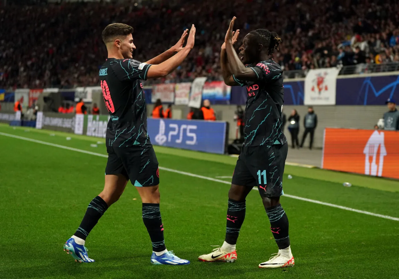 Manchester City's Jeremy Doku (right) celebrates with Julian Alvarez after scoring their side's third goal of the game during the UEFA Champions League Group G match at the Red Bull Arena, Leipzig. Picture date: Wednesday October 4, 2023. - Photo by Icon sport