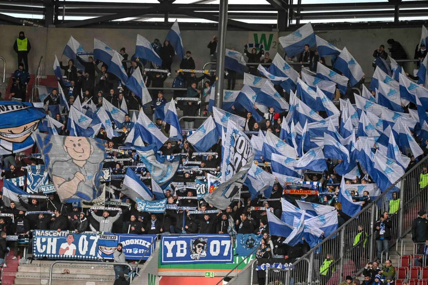 11 November 2023, Bavaria, Augsburg: Soccer: Bundesliga, FC Augsburg - TSG 1899 Hoffenheim, Matchday 11, WWK-Arena. Hoffenheim fans waving flags. Photo: Harry Langer/dpa - IMPORTANT NOTE: In accordance with the regulations of the DFL German Football League and the DFB German Football Association, it is prohibited to utilize or have utilized photographs taken in the stadium and/or of the match in the form of sequential images and/or video-like photo series. - Photo by Icon sport