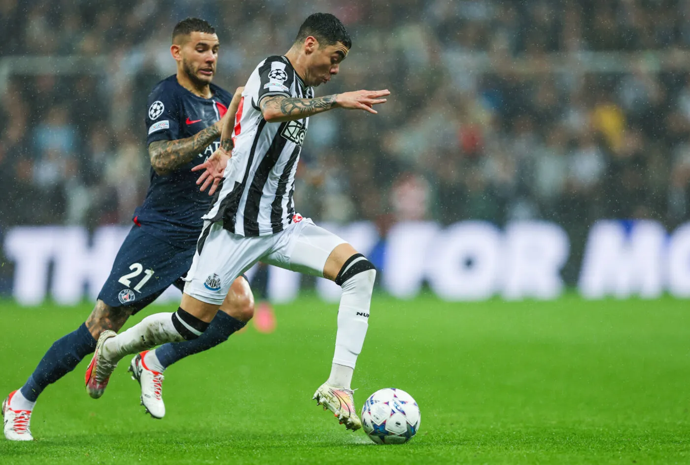Miguel Almirón of Newcastle United is chased down by Lucas Hernández of Paris Saint-Germain during the UEFA Champions League Group F match at St. James's Park, Newcastle