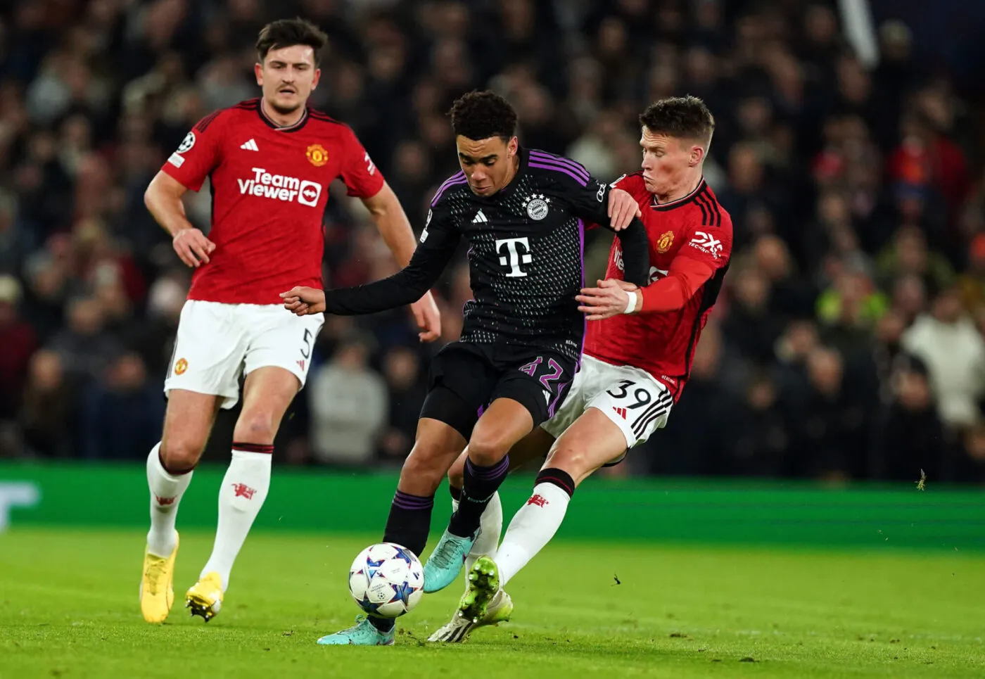 Bayern Munich's Jamal Musiala and Manchester United's Scott McTominay (right) battle for the ball during the UEFA Champions League, Group A match at Old Trafford, Manchester. Picture date: Tuesday December 12, 2023. - Photo by Icon sport