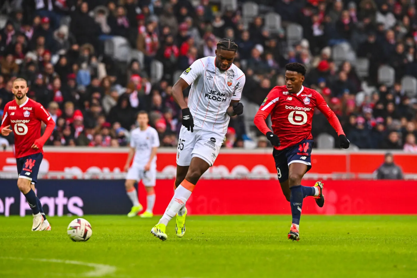 Jonathan DAVID of Lille and Isaak TOURE of Lorient during the Ligue 1 Uber Eats match between Lille OSC and FC Lorient at Stade Pierre Mauroy on January 14, 2024 in Lille, France. (Photo by Daniel Derajinski/Icon Sport)