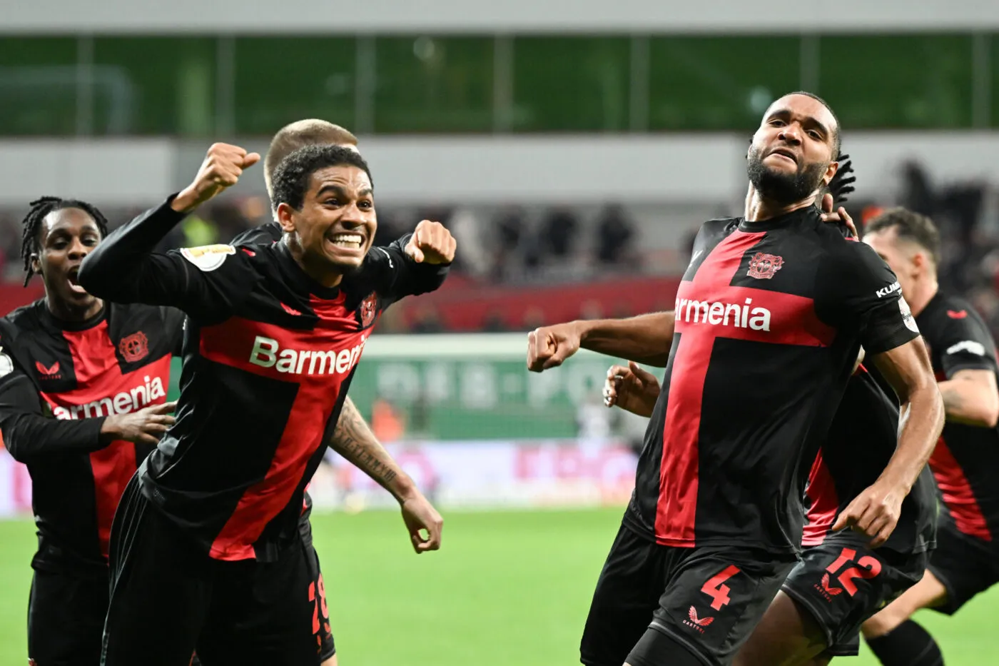 06 February 2024, North Rhine-Westphalia, Leverkusen: Soccer: DFB Cup, Bayer Leverkusen - VfB Stuttgart, quarter-final in the BayArena, Leverkusen's Jonathan Tah (r) celebrates with Amine Adli (2nd from left) after his goal to make it 3:2. IMPORTANT NOTE: In accordance with the regulations of the DFL German Football League and the DFB German Football Association, it is prohibited to use or have used photographs taken in the stadium and/or of the match in the form of sequential images and/or video-like photo series. Photo: Federico Gambarini/dpa - Photo by Icon Sport