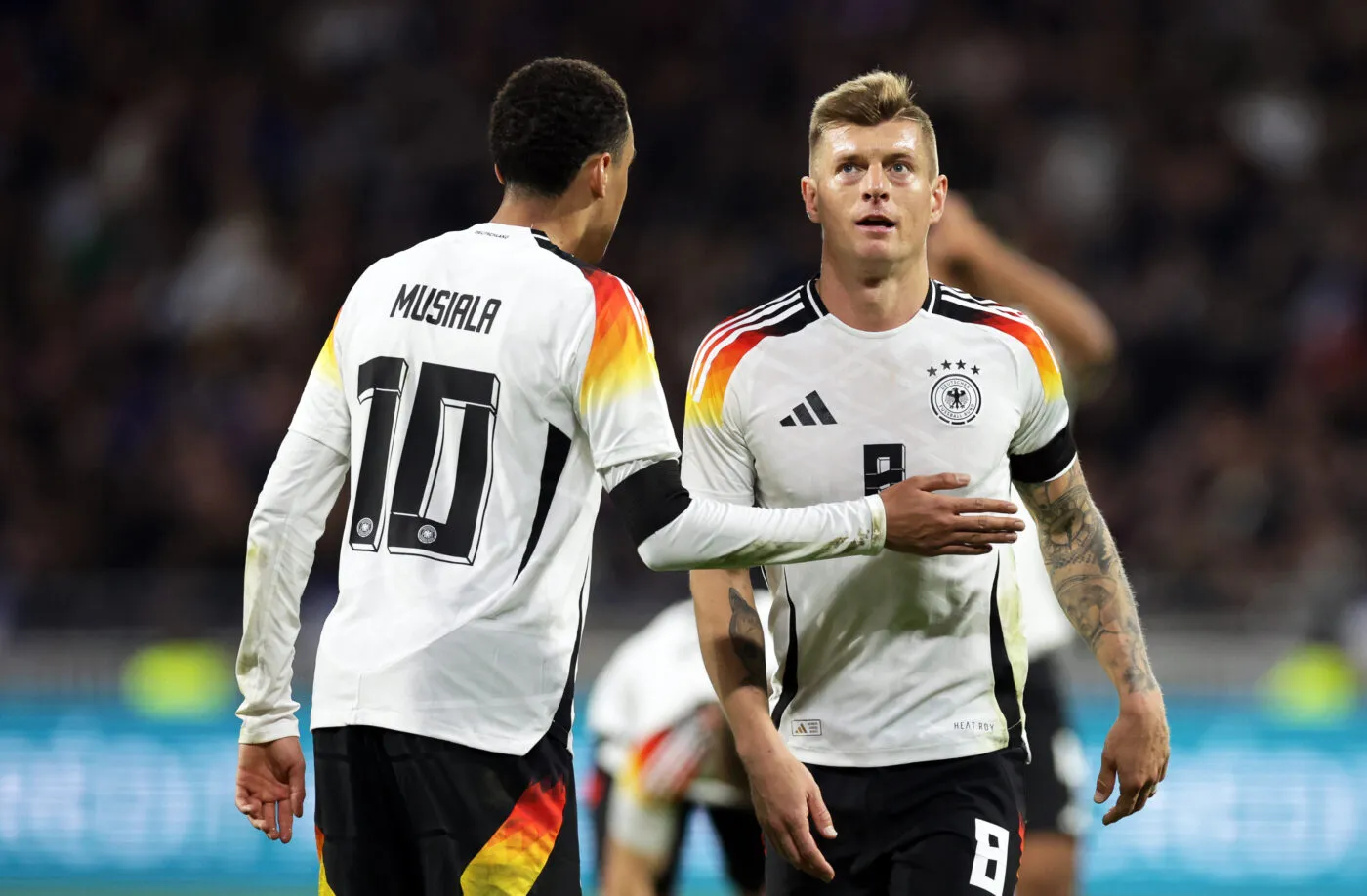 23 March 2024, France, Lyon: Soccer: International match, France - Germany, Groupama Stadium. Germany's players Jamal Musiala (l) and Toni Kroos react. Photo: Christian Charisius/dpa   - Photo by Icon Sport