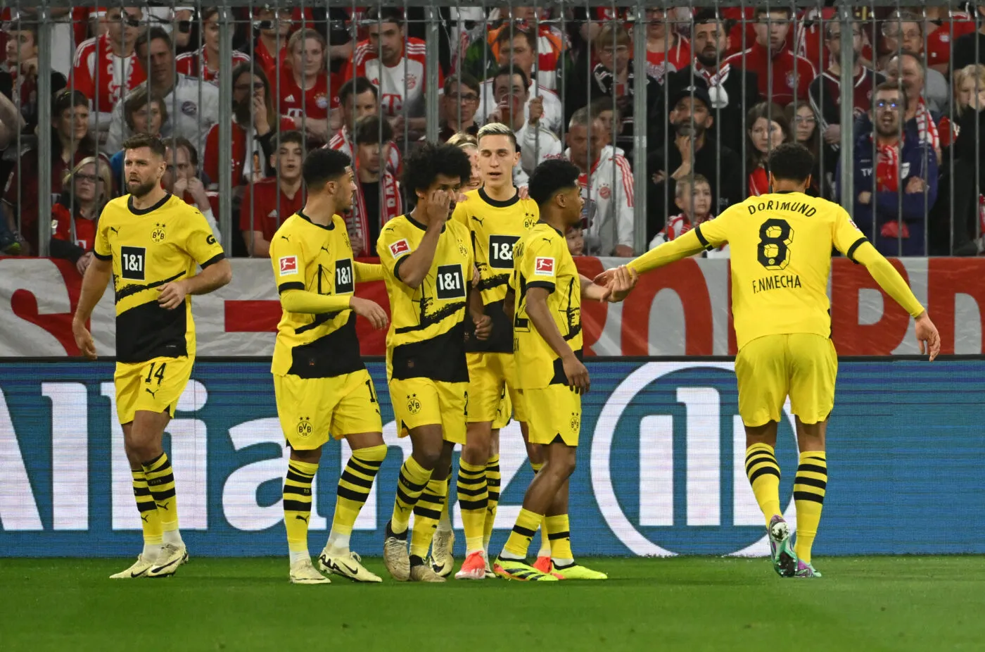 30 March 2024, Bavaria, Munich: Soccer: Bundesliga, Bayern Munich - Borussia Dortmund, Matchday 27, Allianz Arena. The Dortmund players celebrate the first goal scored by Dortmund's Karim Adeyemi (M). IMPORTANT NOTE: In accordance with the regulations of the DFL German Football League and the DFB German Football Association, it is prohibited to exploit or have exploited photographs taken in the stadium and/or of the match in the form of sequential images and/or video-like photo series. Photo: Sven Hoppe/dpa Photo by Icon sport   - Photo by Icon Sport