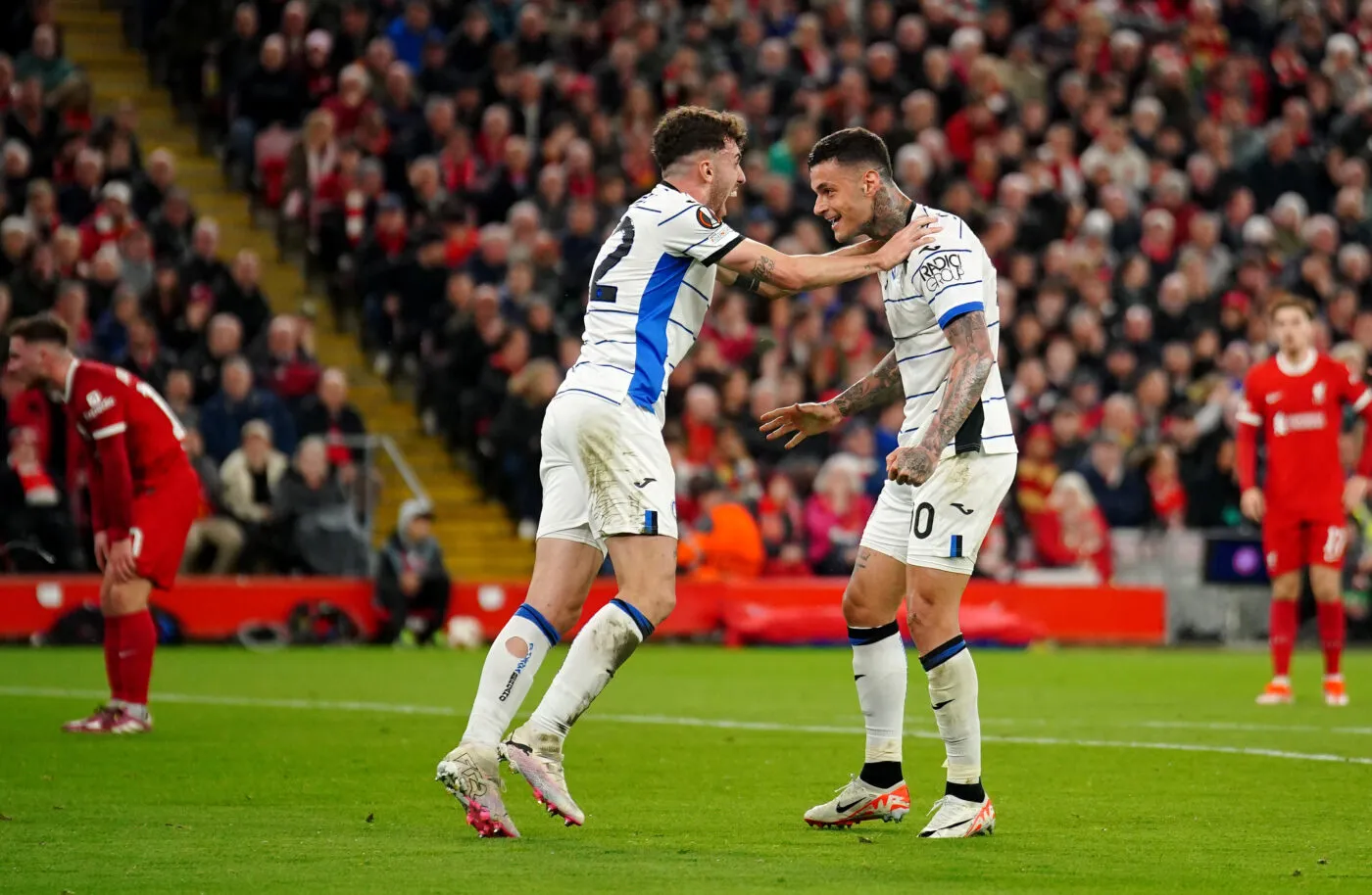 Atalanta's Gianluca Scamacca (right) celebrates with Matteo Ruggeri after scoring their first goal of the game during the UEFA Europa League quarter-final, first leg match at Anfield, Liverpool. Picture date: Thursday April 11, 2024.   - Photo by Icon Sport