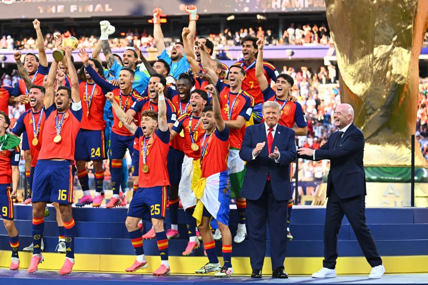 19 July 2026, United States, East Rutherford: Soccer, Men, 2026 World Cup, Final, Spain vs. Argentina, New York-New Jersey Stadium in East Rutherford; Rodri (Spain) (left) celebrates with the World Cup trophy during the award ceremony. On the right, U.S. President Donald Trump and FIFA President Gianni Infantino join in the celebration. PLEASE NOTE: In accordance with FIFA regulations, these images may be used exclusively for editorial purposes. Commercial use is prohibited. Furthermore, no video-like sequences may be created, and no alterations may be made to the image, either in the foreground or the background. Photo: Tom Weller/dpa - Photo by Icon Sport